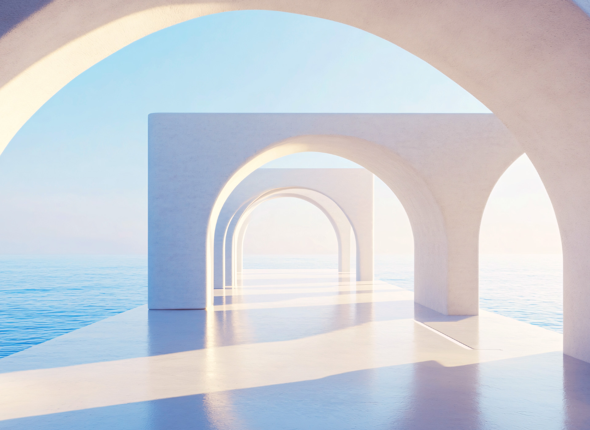 Enfilade d’arches minimalistes ouvertes sur la mer dans une architecture lumineuse