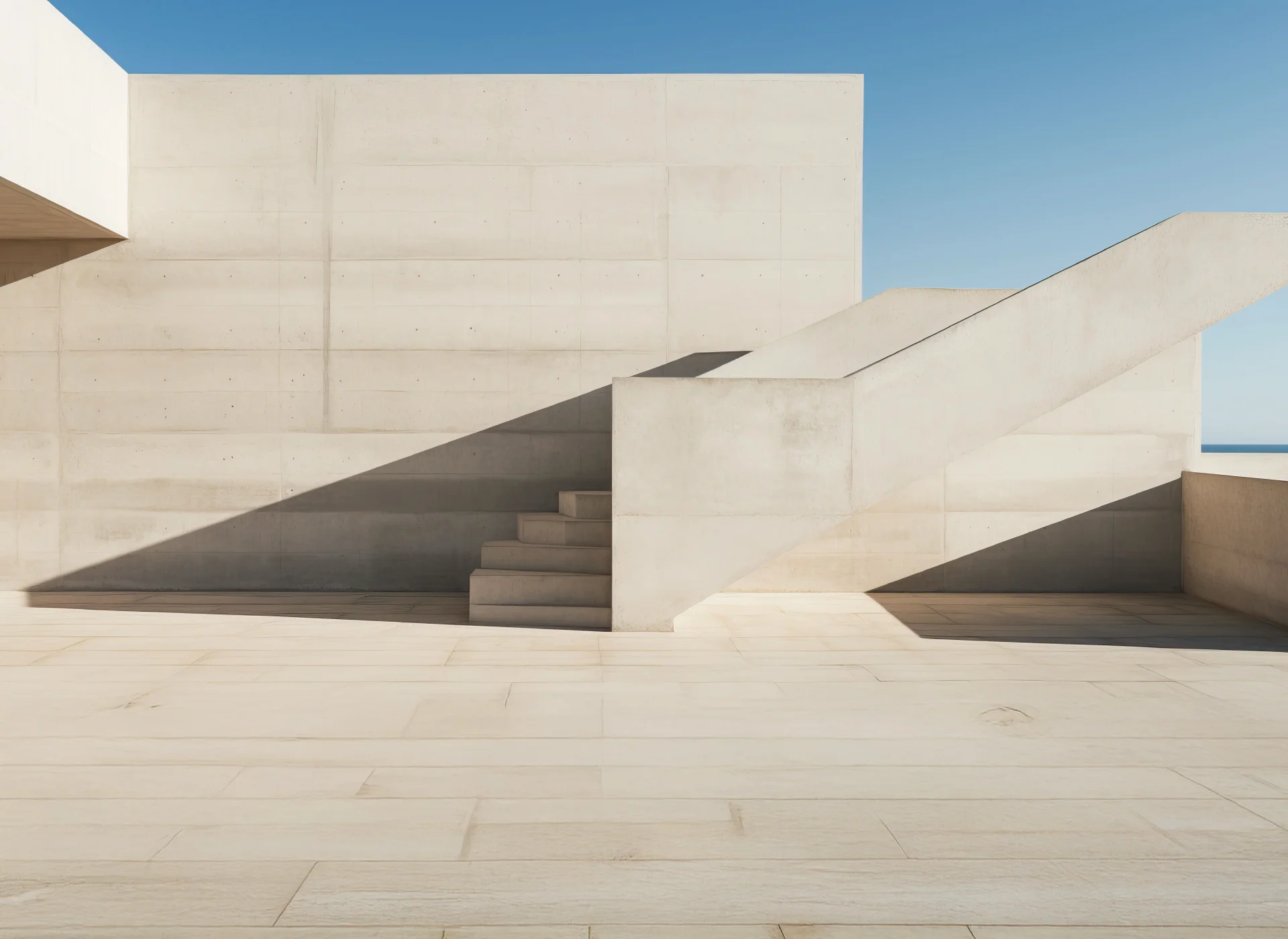 Architecture minimaliste en béton avec escalier extérieur et ciel bleu
