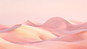 Dunes de sable rose et pêche striées par le vent sous un ciel pastel