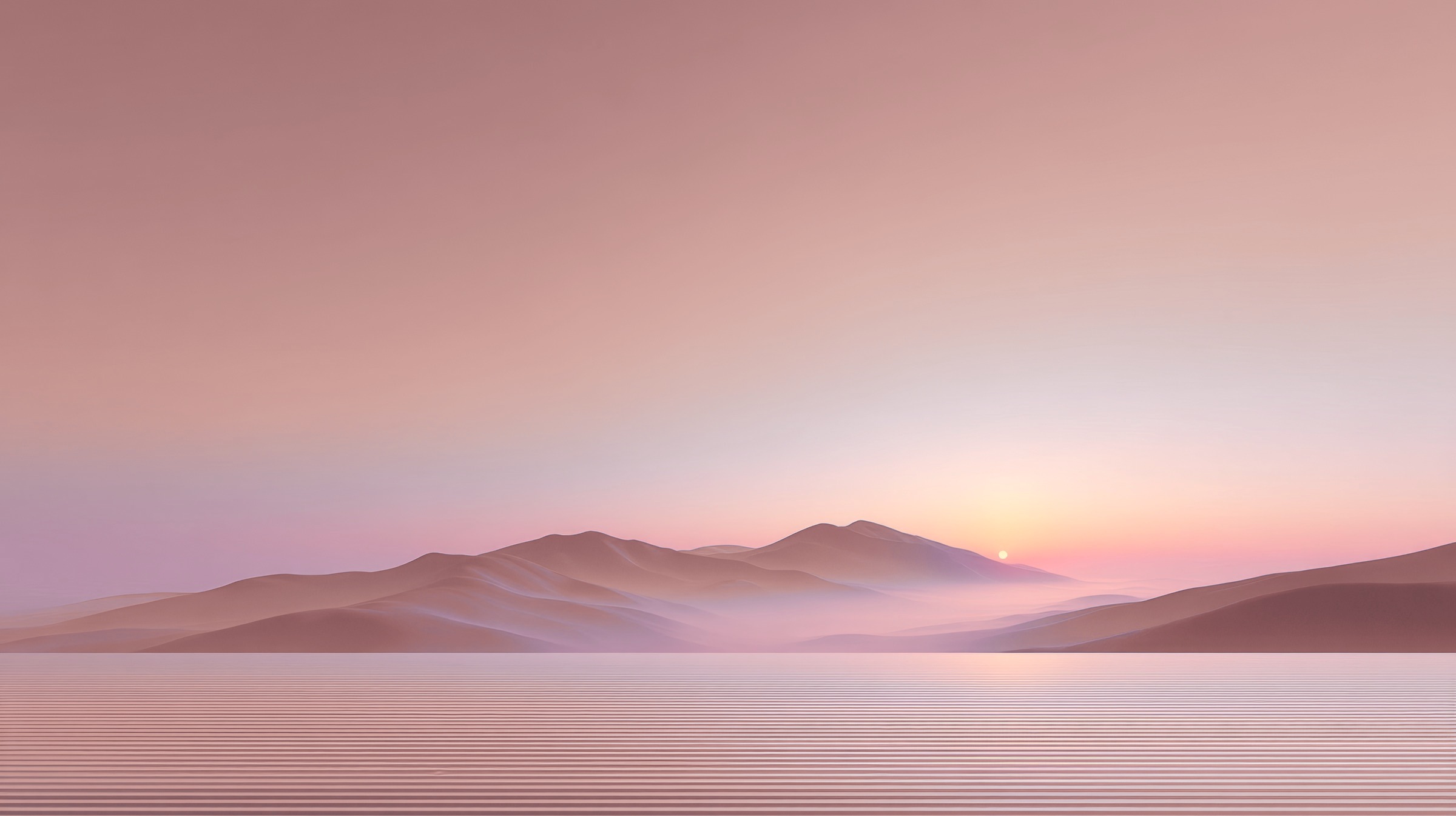 Collines roses dans la brume au coucher du soleil près d'une étendue d'eau